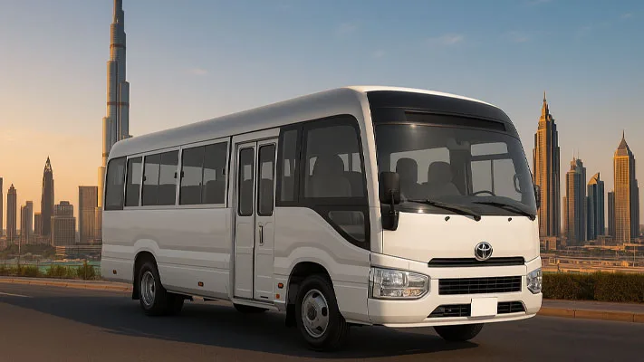 2024 Toyota Coaster High Roof 50-Seater Bus available for rent in Dubai, featuring a 4.2L diesel engine and spacious seating.